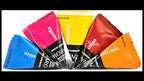 five triangular sachets of coffee flavouring in different colours (blue, pink, yellow, dark red, orange) arranged in a fan shape on a white background.